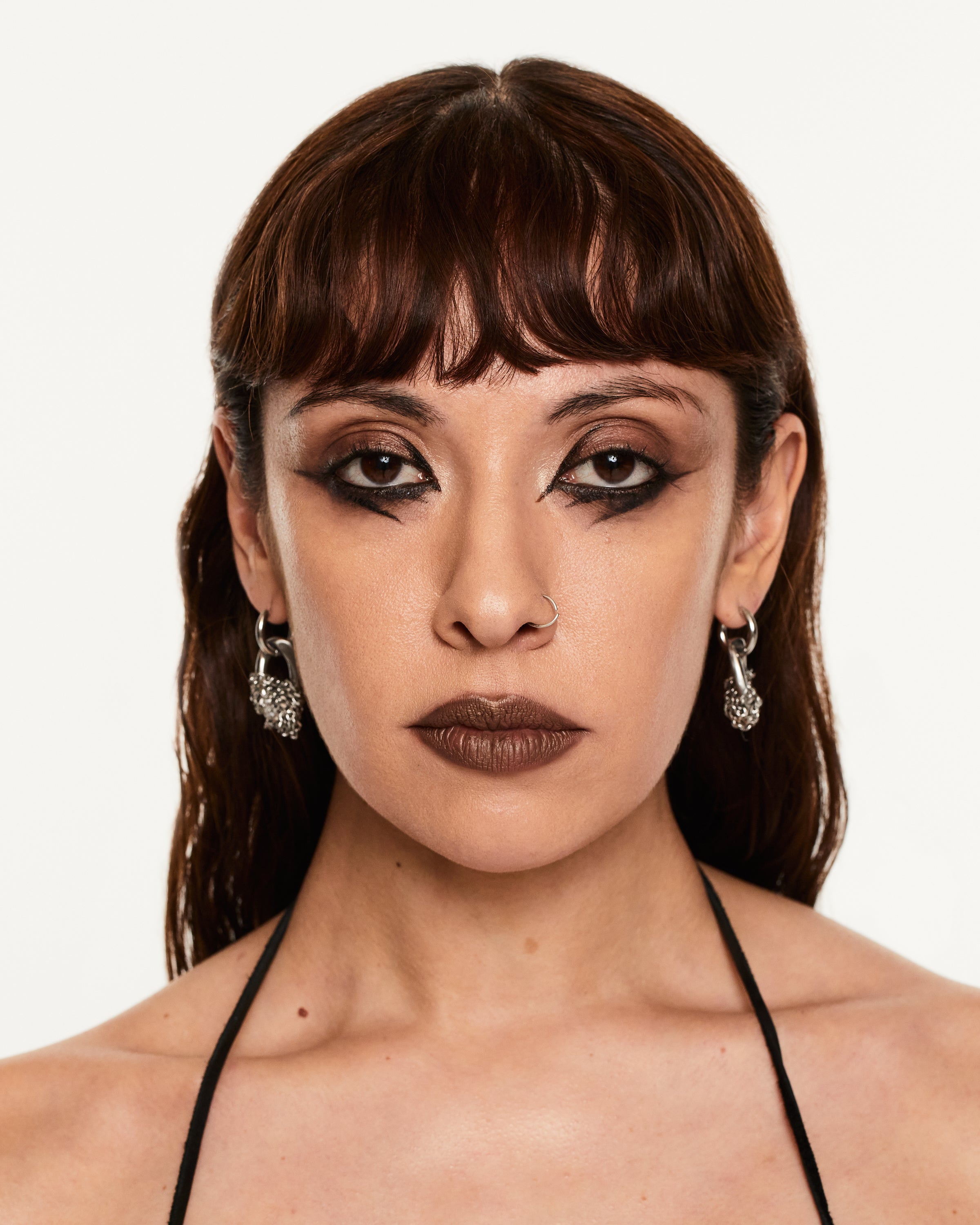 MODEL WITH HOOP DANGLE EARRING AND KNOTTED CHAINS
