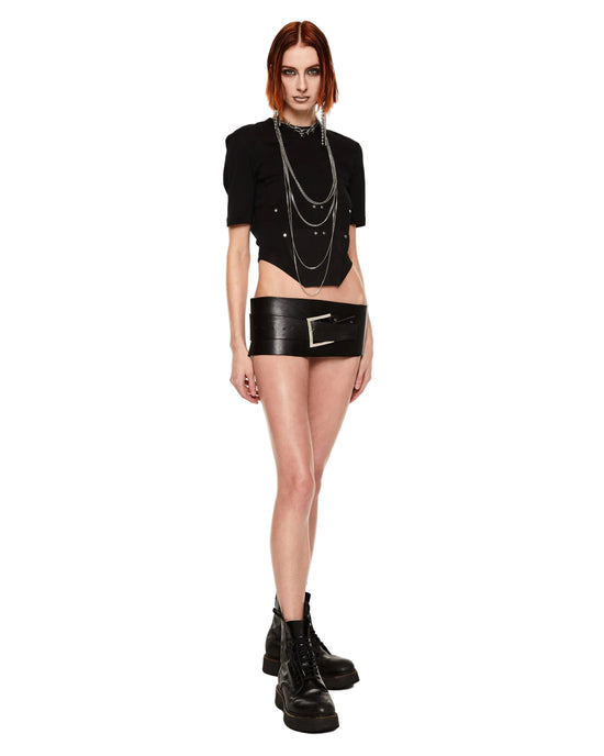 Person wearing a black outfit with a belt and boots on a white background