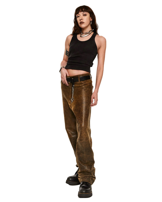Person wearing a black tank top and brown leather pants on a white background