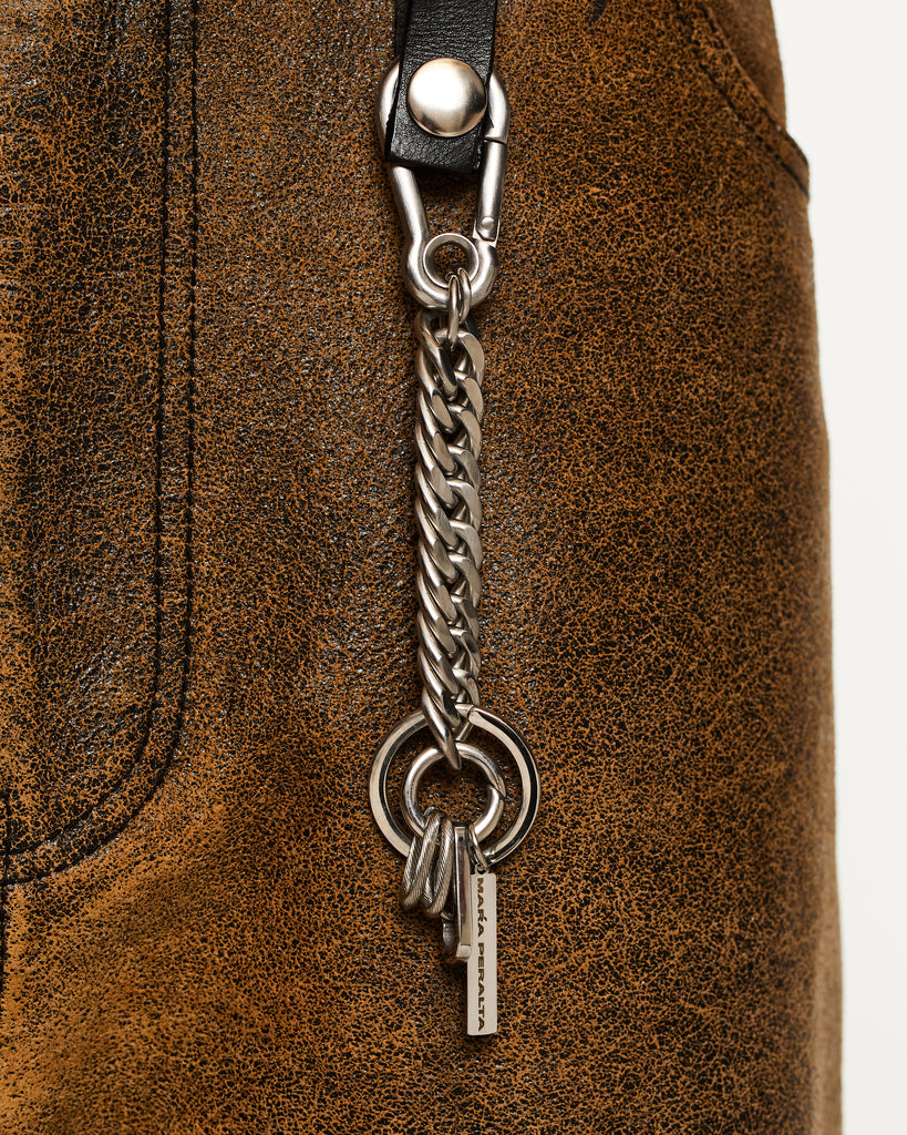 Silver keychain with chain and small charms on a white background