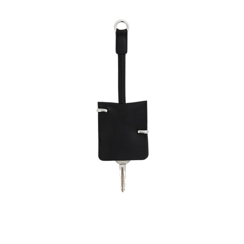 Black key holder with a key on a white background