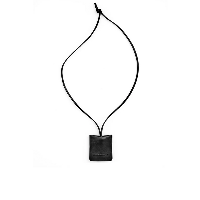 Black lariat necklace on a white background